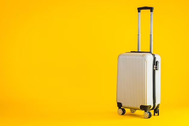 A beige suitcase stands on a yellow background