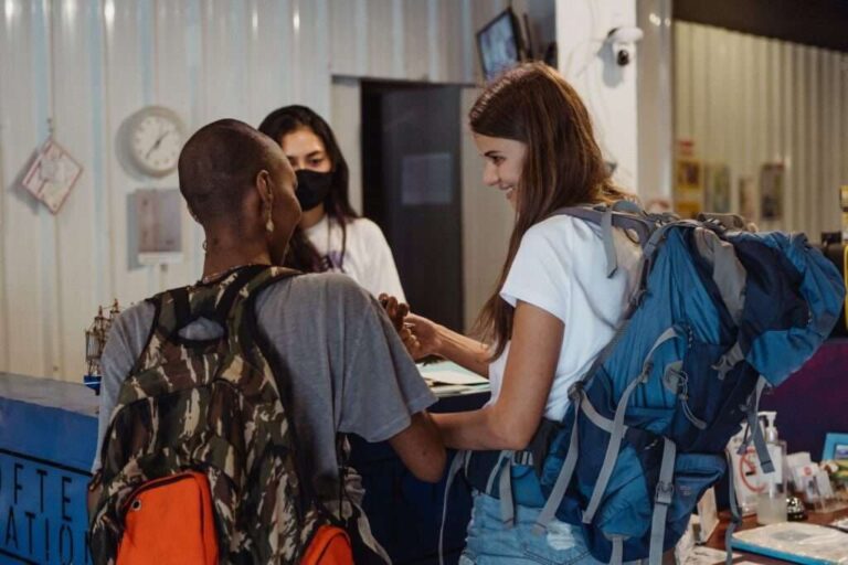 People with a suitcase at the hotel reception