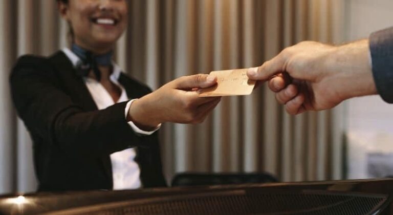 Man gives credit card to hotel receptionist