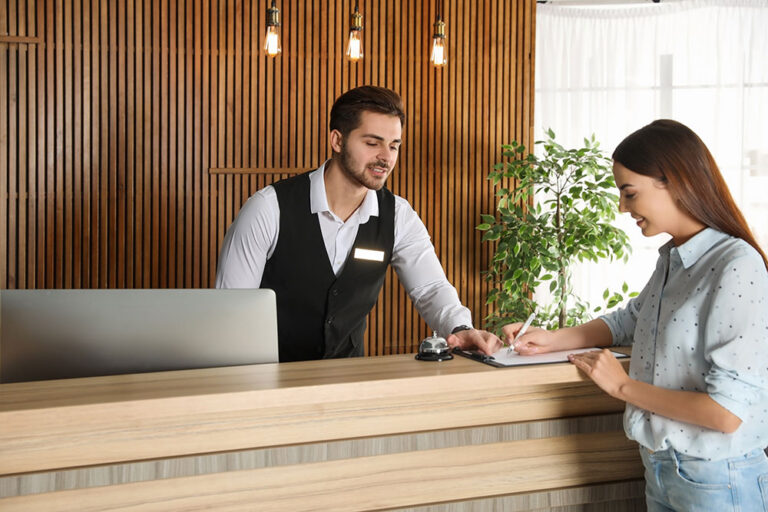 Young man and woman near the reception desk at a hotel