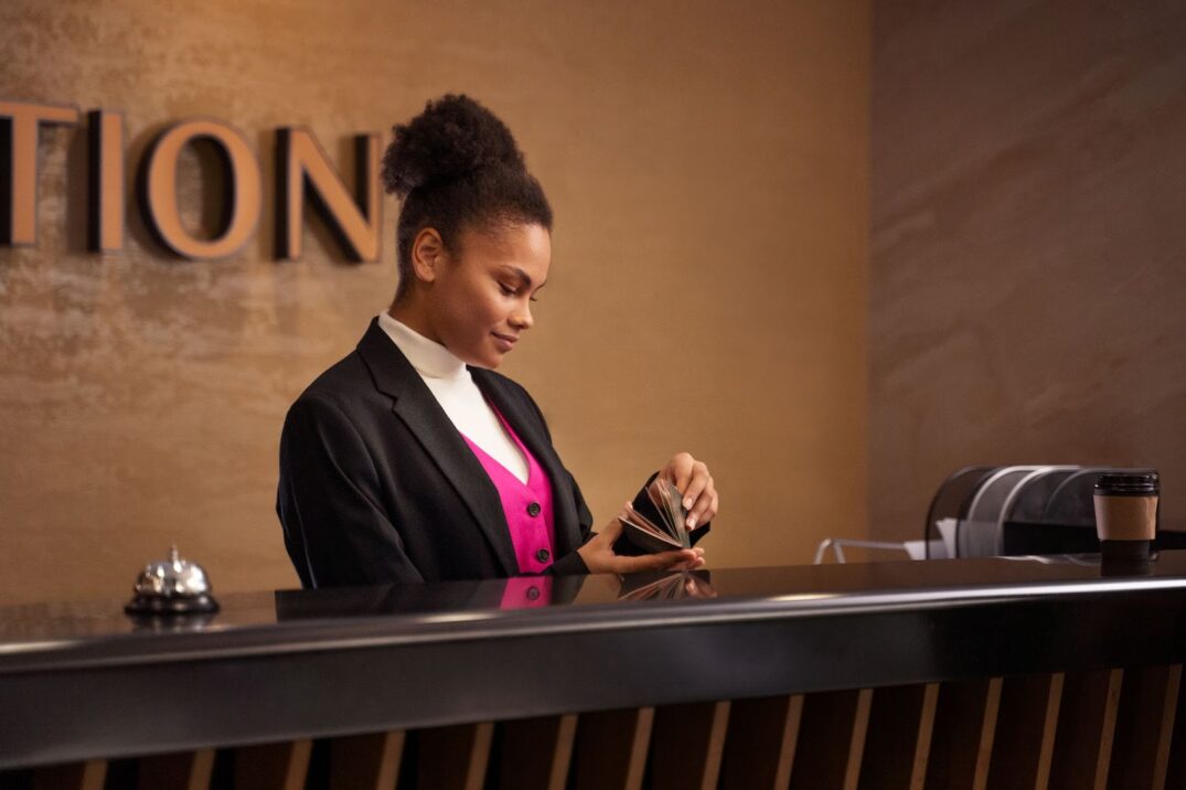 Side view of woman working at hotel reception