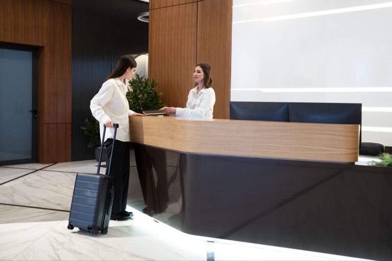 Woman talking with a hotel receptionist in the lobby