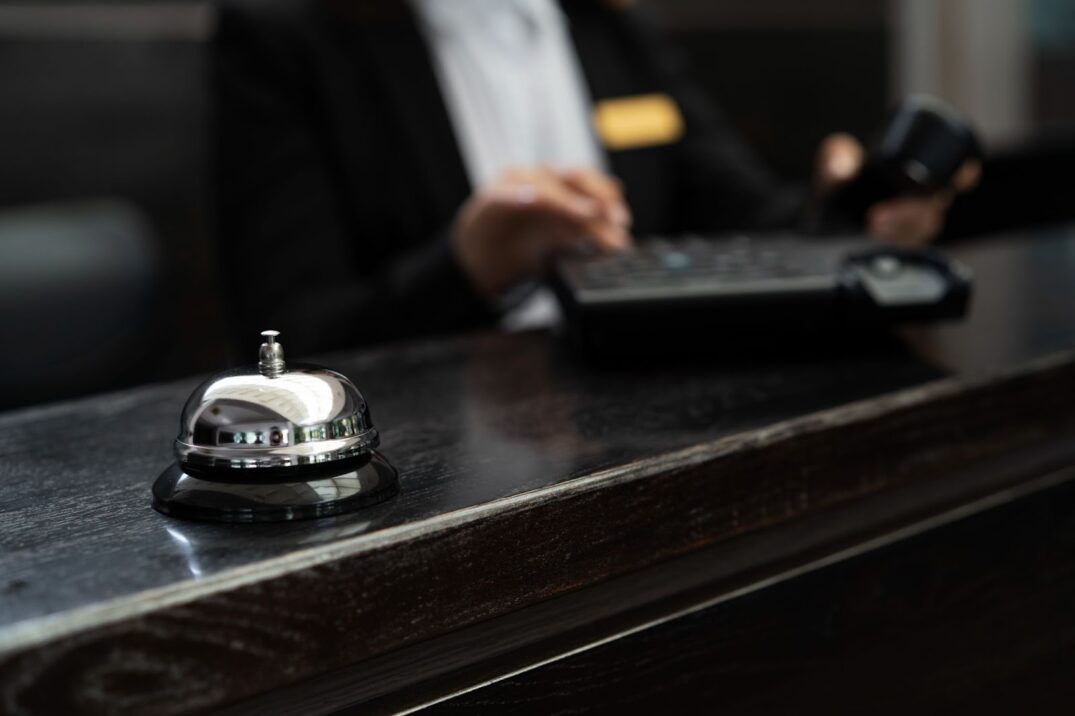 Alt: Close up of receptionist in suit during work hours